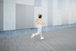 © Lupe Rodríguez/Stocksy - Caucasian female athlete running through the city
