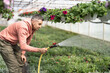 © Andriy Bezuglov/Stocksy - Farmer takes care of his flowers in greenhouse