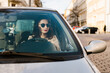 © Irina Efremova/Stocksy - Classically beautiful woman in her car