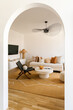 © STUDIO TAURUS/Stocksy - Wall passage leading to stylish living room