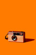 © Juan Moyano/Stocksy - self-customized analog camera on an orange background