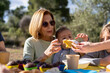 © Albert Martinez/Stocksy - Grandma and grandson taking cake