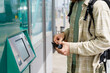 © Alba Vitta/Stocksy - Cropped man buying metro tickets