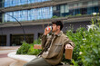 © Alba Vitta/Stocksy - Man drinking coffee take away at public site