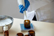 © ALTO IMAGES/Stocksy - Unrecognizable pharmacist pouring skincare product