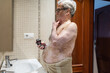 © Lupe Rodríguez/Stocksy - old man with vitiligo in the bathroom