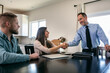 © Sean Locke/Stocksy - Couple Shakes Hands With Financial Advisor At Home