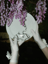 White Dress Gloves Holding A Victorian Plate Among Purple Wisteria 