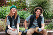 © BONNINSTUDIO/Stocksy - Happy diverse gardeners sitting on bench