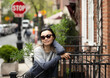 © Lauren Lee/Stocksy - Portrait of woman on stoop