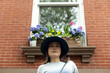 © Lauren Lee/Stocksy - Woman looking down at camera