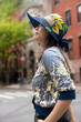 © Lauren Lee/Stocksy - Smiling woman in neighborhood