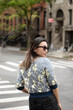 © Lauren Lee/Stocksy - Woman in sunglasses in the city street