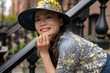© Lauren Lee/Stocksy - Smiling woman on stoop