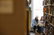 © Ameris Photography Inc./Stocksy - Two friends in library together.