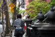 © Lauren Lee/Stocksy - Woman walking in the city
