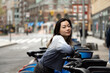 © Lauren Lee/Stocksy - Woman on bike in the city