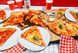 © Carmen Palma/Stocksy - Pizza party table.
