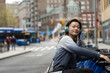 © Lauren Lee/Stocksy - Woman smiling on bike