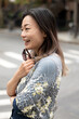 © Lauren Lee/Stocksy - Happy woman in neighborhood