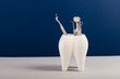 © Painted Wood/Stocksy - huge tooth with dental equipment