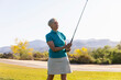 Determined Senior Citizen Woman Playing Golf 