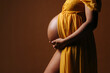 © VICTOR TORRES/Stocksy - Crop pregnant woman touching belly