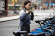 © Lauren Lee/Stocksy - Woman on the go in the city