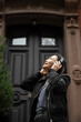 © Lauren Lee/Stocksy - Woman with headphones leaving house