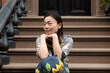 © Lauren Lee/Stocksy - Woman sitting on stoop