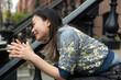 © Lauren Lee/Stocksy - Woman sitting on stoop
