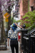 © Lauren Lee/Stocksy - Woman walking down sidewalk