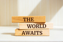 Wooden Blocks With Words 'The World Awaits'.
