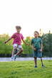 © Santi Nuñez/Stocksy - Funny moment of two children in the park