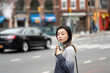 © Lauren Lee/Stocksy - Woman on the go in city