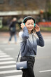 © Lauren Lee/Stocksy - Woman on the go looking at camera