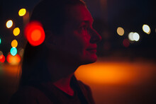 Red Light Portrait Of A Woman With Blurred City Lights