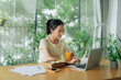© Marc Tran/Stocksy - Pretty young business woman eating healthy salad in office