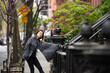 © Lauren Lee/Stocksy - Woman on sidewalk smiling