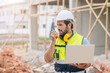 © Quality Stock Arts - worker foreman engineer builder working using radio command in home construction site safety check.