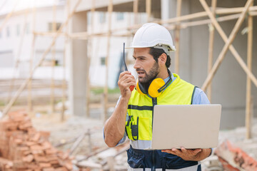 Wall Mural - worker foreman engineer builder working using radio command in home construction site safety check.