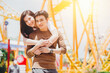 © Quality Stock Arts - Portrait Asian couple lover happy outdoors at amusement park holiday activity together with copy space.