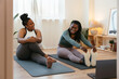 © BONNINSTUDIO/Stocksy - Black mom and daughter exercising at home together