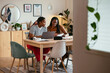 © BONNINSTUDIO/Stocksy - Black student doing homework with mom