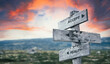 accept the reality text quote caption on wooden signpost outdoors in nature with dramatic sunset skies. Panorama crop.