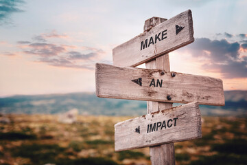 make an impact text quote caption on wooden signpost outdoors in nature. stock sign words theme.