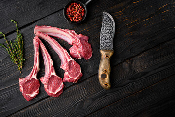 Fresh meat cutlet, on black wooden table background, top view flat lay, with copy space for text