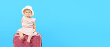 Cute Baby Girl With Suitcase On Blue Background With Space For Text