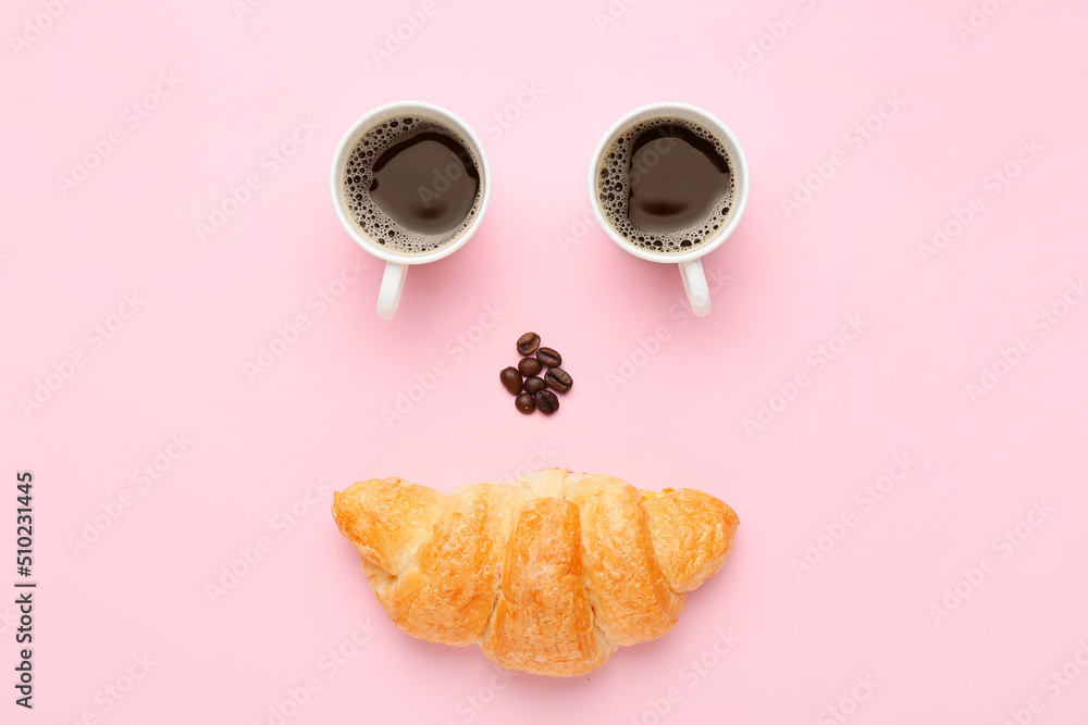 Creative composition with cups of coffee, beans and croissant on pink background