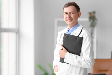 Wall Mural - Male medical assistant with clipboard at hospital